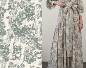 May include: A long, white dress with a green and white floral print. The dress has a high neck, long sleeves, and a tie at the waist.
