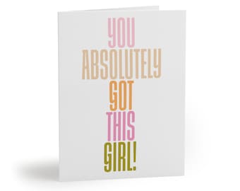 May include: A white card with the text "YOU ABSOLUTELY GOT THIS GIRL!" in different colors. The text is stacked vertically, with "YOU" in pink, "ABSOLUTELY" in beige, "GOT" in orange, "THIS" in pink, and "GIRL!" in green.