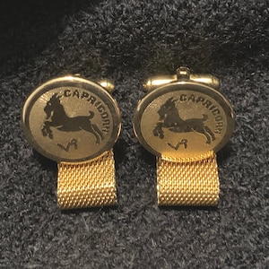 Capricorn gold tone mesh wraparound cufflinks marked &quot;Danté&quot;