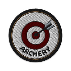 May include: A black and white embroidered patch with a red and white target and an arrow in the center. The text "ARCHERY" is written below the target.