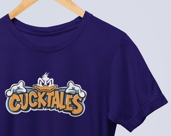 May include: A dark blue t-shirt with a cartoon duck wearing a crown and the text "CUCKTALES" in orange and yellow letters.