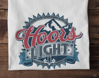 May include: White t-shirt with a vintage-style logo for "Coors Light" featuring a mountain range and a blue ribbon.