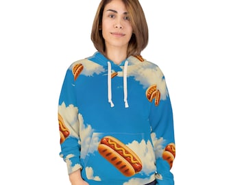 May include: A long-sleeve hooded sweatshirt featuring an all-over print of hot dogs floating against a bright blue sky with white clouds. The hoodie includes a front kangaroo pocket, white drawstrings, and ribbed cuffs on the sleeves and hem.