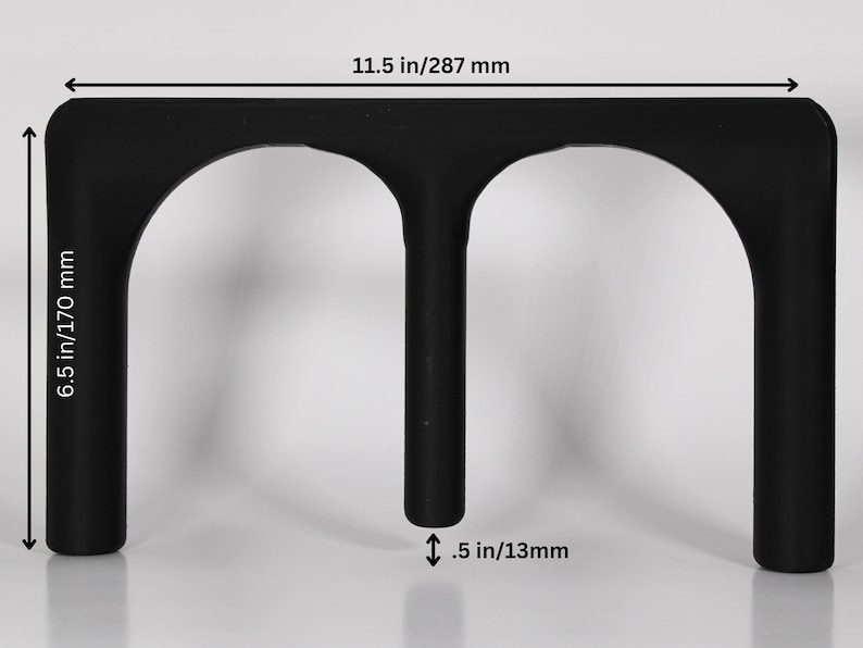 May include: Black plastic stand with two arched openings, measuring 287 mm wide, 170 mm tall, and 13 mm thick.