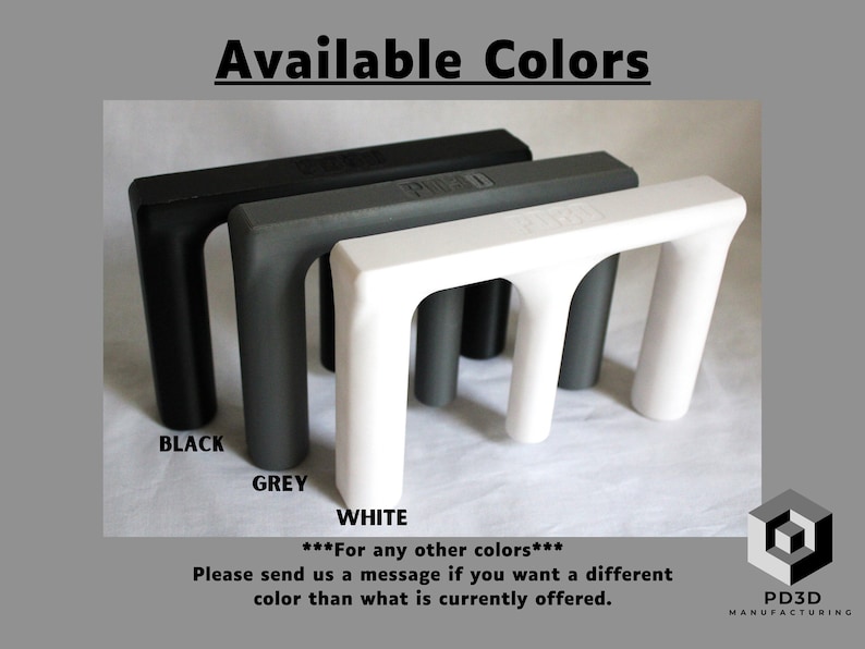 May include: Three 3D printed objects in black, gray, and white. The objects are shaped like a letter 'M' and are available in different colors. The text 'Available Colors' is at the top of the image. The text 'BLACK', 'GREY', and 'WHITE' are below the objects. The text '***For any other colors*** Please send us a message if you want a different color than what is currently offered.' is below the colors. The text 'PD3D MANUFACTURING' is at the bottom right of the image.