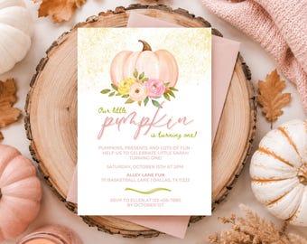 May include: A rectangular invitation card featuring a watercolour illustration of a pale pink pumpkin with yellow and pink flowers. The text reads: Our little pumpkin is turning one! Pumpkins, presents and lots of fun - help us to celebrate little Sarah turning one! Saturday, October 15th at 2pm, Alley Lane Fun, 111 Basketball Lane, Dallas, TX 11223, RSVP to Ellen at 123-456-7890 by October 1st.