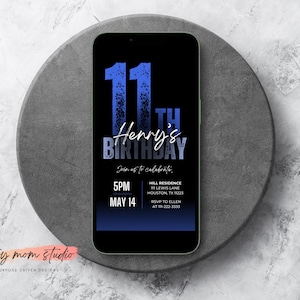 May include: A black smartphone displays a birthday invitation. The invitation features blue text that reads "11th Birthday" and "Henry's." The invitation includes the time, date, and location of the event. The phone rests on a gray, circular stone surface.