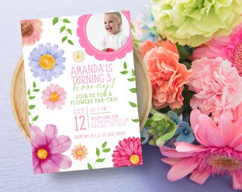 May include: A pink and white birthday invitation with a watercolor floral design. The invitation says "Amanda is turning 3! hooray!" and includes details for a "flowery par-tay!" on October 12th at 3 PM at Alley Lane Fun, 111 Basketball Ln, Dallas, TX 11223. RSVP by 10-11, 111-222-3333.