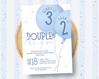 May include: A light blue birthday invitation featuring two watercolour balloons. The invitation reads "Double the Fun" and includes the names Henry and Adam, with their ages, and event details. The invitation is on a wooden plate.