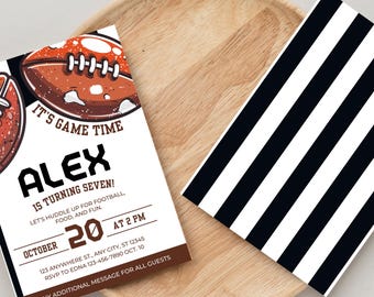 May include: Football-themed invitation with a brown and white football graphic and the text "IT'S GAME TIME ALEX IS TURNING SEVEN!" The invitation is on a wooden tray next to a black and white striped paper.