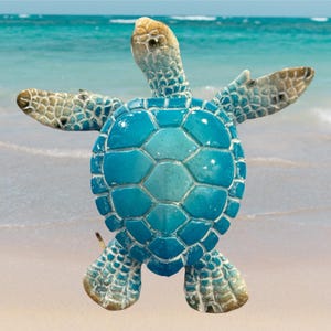 May include: A blue and white ceramic sea turtle figurine with a textured shell. The turtle is facing forward with its head raised and its flippers outstretched.