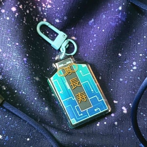 Charm Omamori de lámina dorada de Mr Roboto