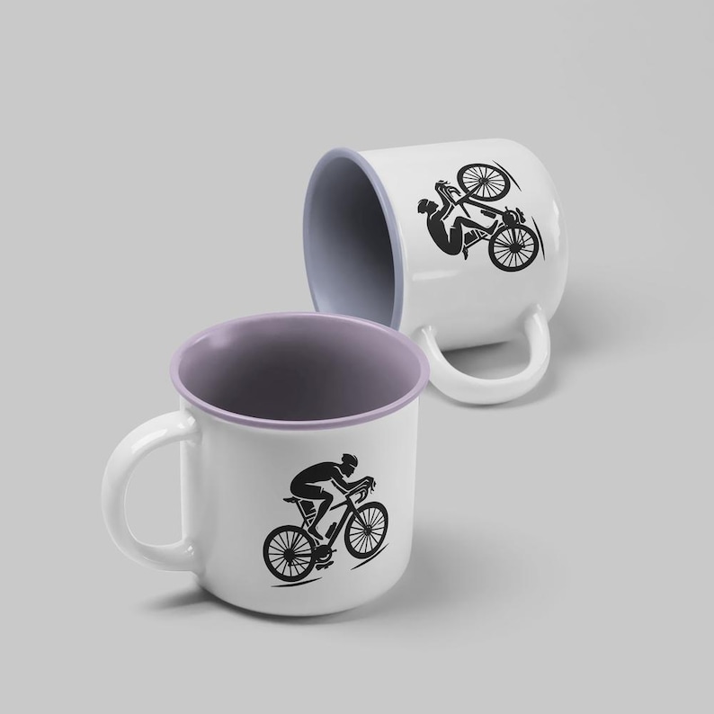 May include: Two white ceramic mugs with a black silhouette of a cyclist riding a bicycle. One mug has a purple rim and handle, the other has a white rim and handle.