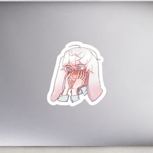 May include: A sticker featuring a cartoon character with white hair and pink cheeks, wearing a white shirt and a pair of bunny ears. The character is covering their face with their hands, and their eyes are closed.