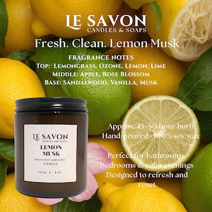 May include: A brown glass jar candle with a black lid, labeled "Lemon Musk" with fragrance notes. The candle is 8 oz and hand-poured with 100% soy wax. The background features lemons, limes, and text that reads "Fresh. Clean."