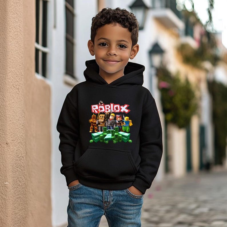 May include: A black hoodie with a graphic of Roblox characters and the word "Roblox" in red. The characters are standing on a pile of green cash.