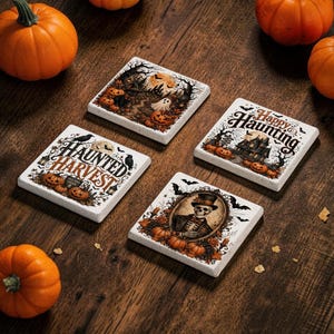 May include: Four square white coasters featuring Halloween-themed illustrations. One shows a ghost in a forest, another says Happy Haunting with a house, one says Haunted Harvest with pumpkins, and the last depicts a skeleton in a top hat.