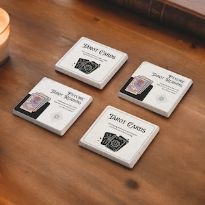 May include: Four white square coasters with black and white illustrations of tarot cards. The coasters feature the text "Tarot Cards" and "Psychic Reading".