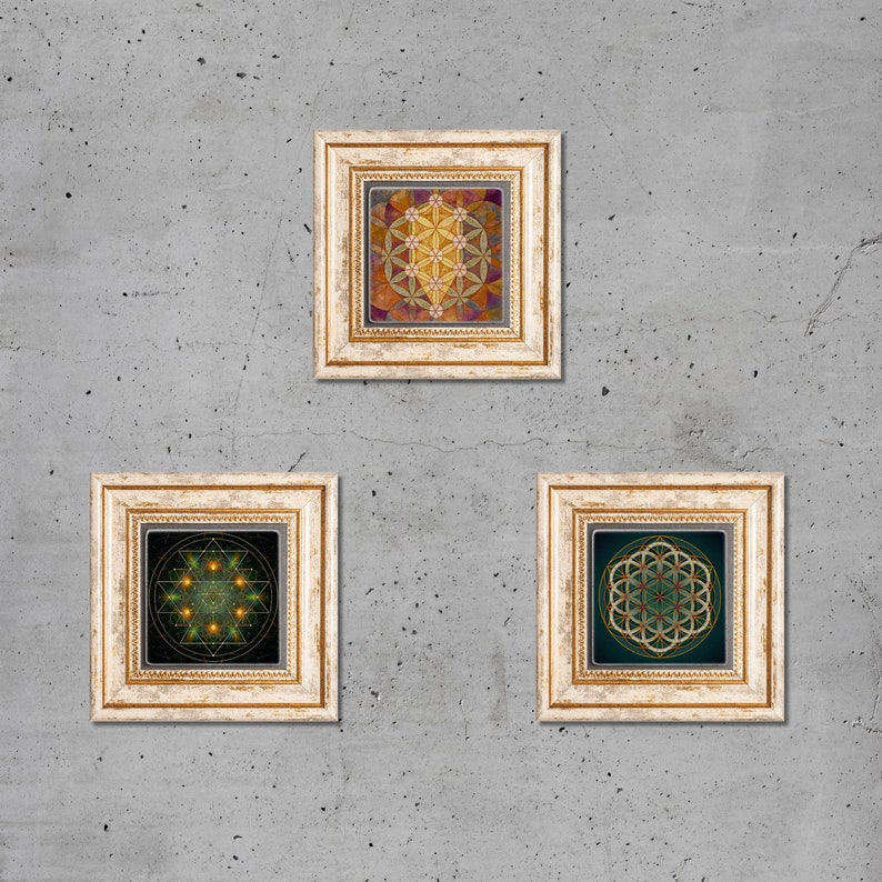 May include: Three framed prints with geometric designs in gold frames. The top print features a flower of life design in shades of yellow, orange, and red. The left print features a geometric design in shades of green and gold. The right print features a flower of life design in shades of green and gold.
