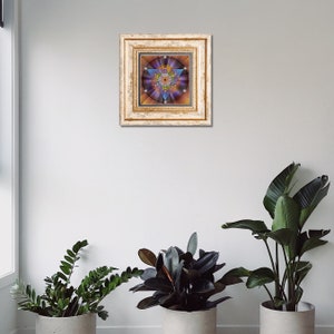 May include: A framed print of a colorful geometric design with a star shape in the center. The frame is gold with a white background.
