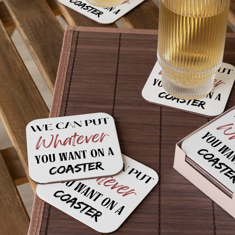 Puede incluir: Conjunto de cuatro posavasos cuadrados blancos con texto negro que dice "We can put whatever you want on a coaster". Los posavasos est&aacute;n apilados uno encima del otro.