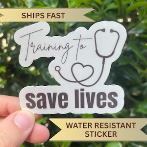 May include: A white sticker with the text "Training to save lives" and a stethoscope graphic. The sticker also has the text "Water Resistant Sticker".