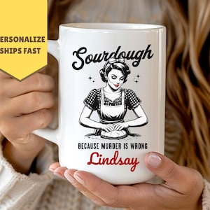 May include: White ceramic mug with the word "Sourdough" in a script font. The mug features a black and white illustration of a woman kneading dough, with the text "BECAUSE MURDER IS WRONG" and a personalized name in red.