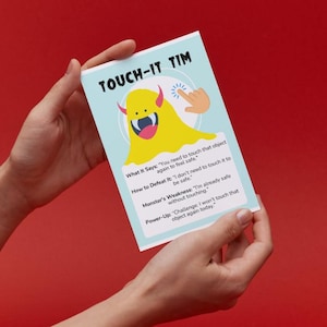 May include: A blue and yellow card with a cartoon monster on it. The card says "Touch-It Tim" and has instructions on how to defeat the monster. The monster says "You need to touch that object again to feel safe".