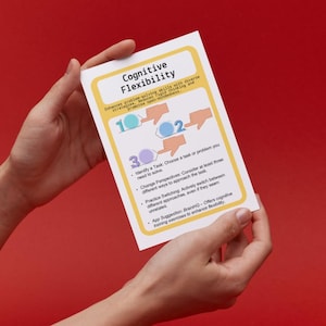 May include: A yellow card with the title "Cognitive Flexibility" and a diagram showing three steps to improve cognitive flexibility. The steps are: Identify a Task, Change Perspectives, and Practice Switching. The card also includes a suggestion to use the BrainHQ app to enhance cognitive flexibility.