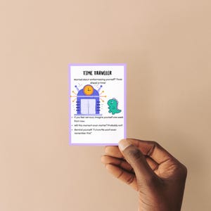 May include: A Time Traveler card with a purple border, held by a hand. The card features a cartoon image of a time machine and a green dinosaur. Text on the card reads: "Worried about embarrassing yourself? Think ahead in time!"