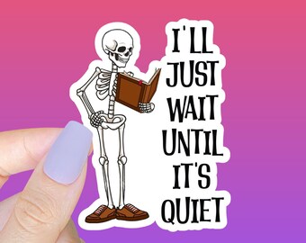 May include: A sticker featuring a skeleton holding a book and the text "I'll just wait until it's quiet".