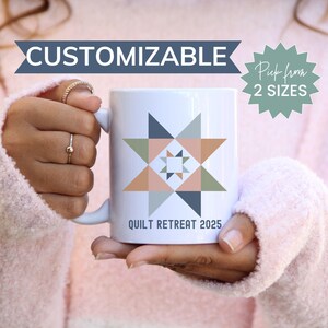 May include: White ceramic mug with a geometric design in shades of pink, blue, and green. The mug has the text "Quilt Retreat 2025" printed on the bottom.  The mug is customizable and available in two sizes.