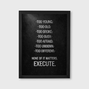 May include: Black framed print with white text on a dark background. The text includes phrases like "TOO YOUNG," "TOO OLD," and "EXECUTE." A motivational piece for home or office decor.