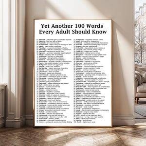 May include: A framed poster displaying the text "Yet Another 100 Words Every Adult Should Know." The poster features a list of 100 words with definitions, such as "benign," "candid," and "dubious."