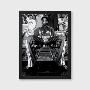 May include: Black and white framed print featuring a seated basketball player in a warm-up suit. The text "Master Your Mind" is displayed across the bottom. The background shows a crowd of people.