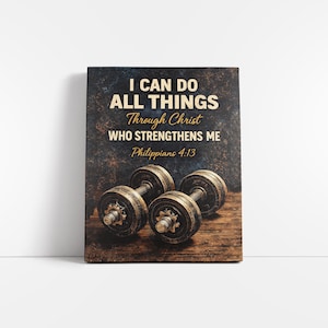 May include: A canvas print featuring the text "I CAN DO ALL THINGS Through Christ WHO STRENGTHENS ME Philippians 4:13" above two dumbbells. The background has a dark, textured appearance with a wooden base.
