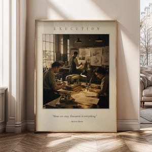 Puede incluir: Una lámina de arte enmarcada con una escena en tonos sepia de tres personas trabajando en un taller con dibujos técnicos y herramientas. El texto en la parte superior dice E X E C U T I O N y el texto en la parte inferior dice "Ideas are easy. Execution is everything." - Business Maxim.