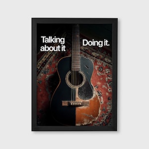 May include: Framed print featuring a vintage acoustic guitar, split vertically with a black finish on the left and a worn, natural wood finish on the right. The text "Talking about it" and "Doing it" are displayed in white.