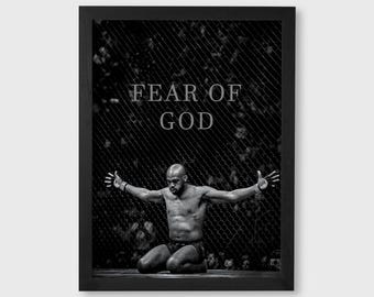 May include: Black and white framed print featuring a kneeling person with arms outstretched. The text "FEAR OF GOD" is above the person. The background includes a chain-link fence.