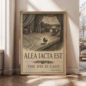 May include: A vertical poster featuring a black and white ink-style illustration of a die being cast over a stone ledge overlooking a river and bridge. The text reads ALEA IACTA EST, THE DIE IS CAST, and Julius Caesar in a serif font.
