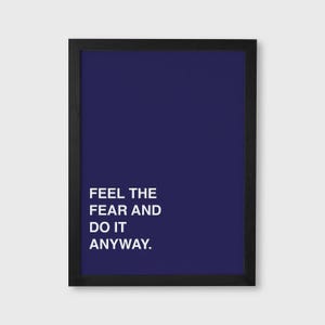 May include: A framed print with a dark blue background and the white text "FEEL THE FEAR AND DO IT ANYWAY." The frame is black. This motivational art piece is suitable for home or office decor.