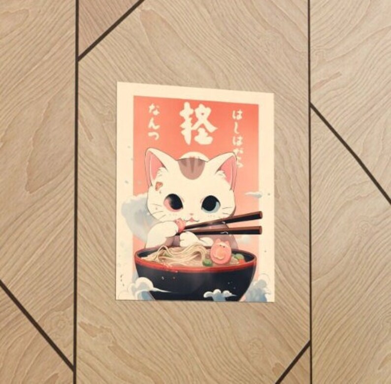 May include: A white cat with one blue eye and one red eye is eating ramen noodles from a bowl with chopsticks. The Japanese text on the poster says "Itadakimasu" and "Ramen".