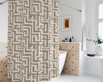 May include: A beige shower curtain with a geometric pattern of brown lines forming a maze-like design. The curtain is hanging in a bathroom with a white bathtub and a tiled wall.