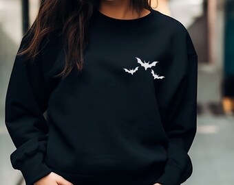 May include: Black sweatshirt with a white silhouette of three bats on the front.