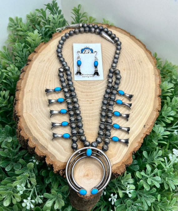 All Nations Trading - An adorable little Squash Blossom Necklace in  Stirling Silver and Turquoise. Navajo made. One in stock and you can find  it here. https://spiritfeather.com/Native-American-Squash-Blossom-Necklace--Mini-style_p_2763.html  | Facebook