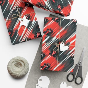 May include: Gift-wrapped presents with red, black, and white abstract racing car pattern. Each package is tied with twine and a white paper tag. A ball of twine, scissors, and blank tags are also visible.