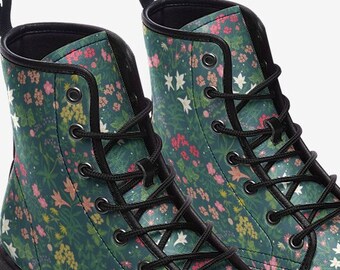 May include: A pair of green ankle boots with a floral print. The boots have black laces and a black sole.