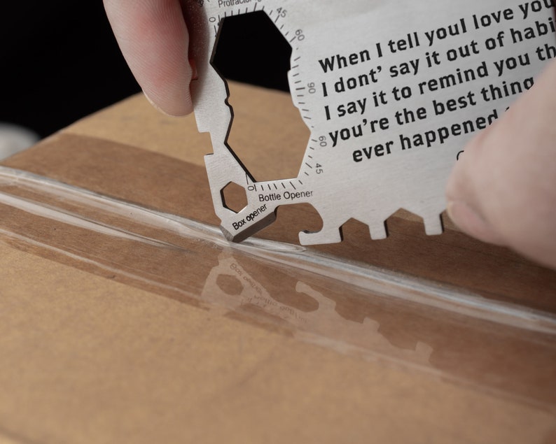 May include: A silver multi-tool with a box opener, bottle opener, and ruler. The tool has a quote engraved on it that reads: "When I tell you I love you I don't say it out of habit I say it to remind you that you're the best thing ever happened".