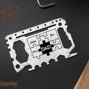 May include: A silver multi-tool with a ruler, bottle opener, and other tools. The tool has a puzzle design with the word "DAD" in the center and the names Liam, Emery, Alessia, Theo, and Charlie around it.