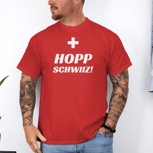 May include: Red t-shirt with a white Swiss flag and the text "HOPP SCHWIIZ!"
